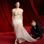 Joaquin Phoenix Fixes Rooney Mara’s Train at Academy Gala